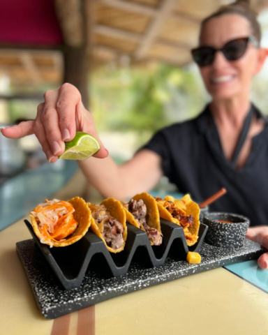 Tiffany squeezing a lime on her tacos