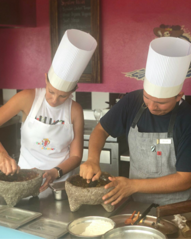 Tiffany making salsa in a Molcajete