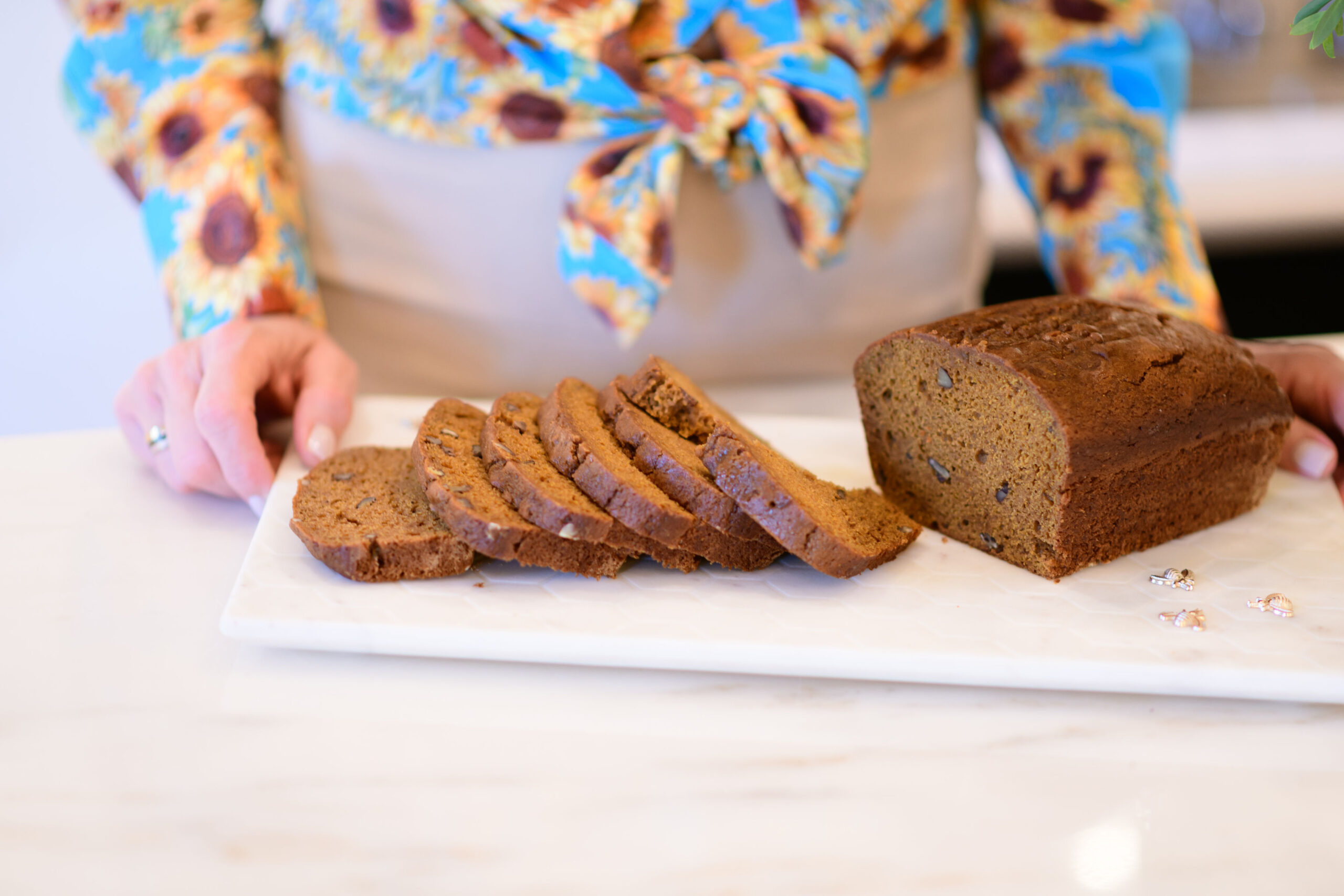 sliced pumpkin bread displayed on white serving tray in kitchen